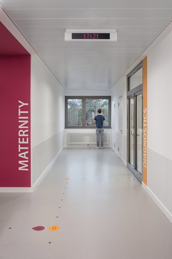 Routing systems on the floor in hospital helps wayfinding, created with nora floor coverings.